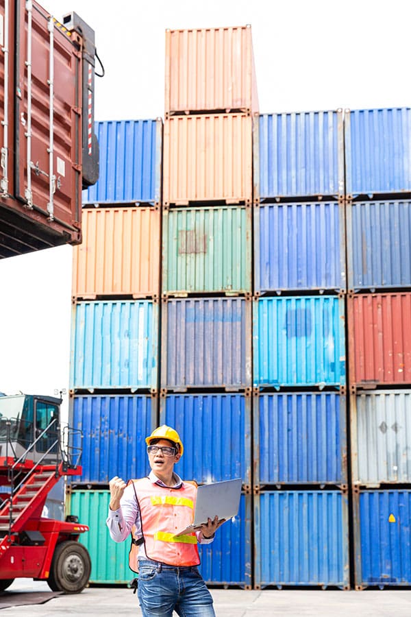 shipping container yard with worker