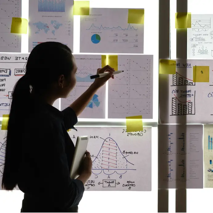 woman analyzing graphs on a wall