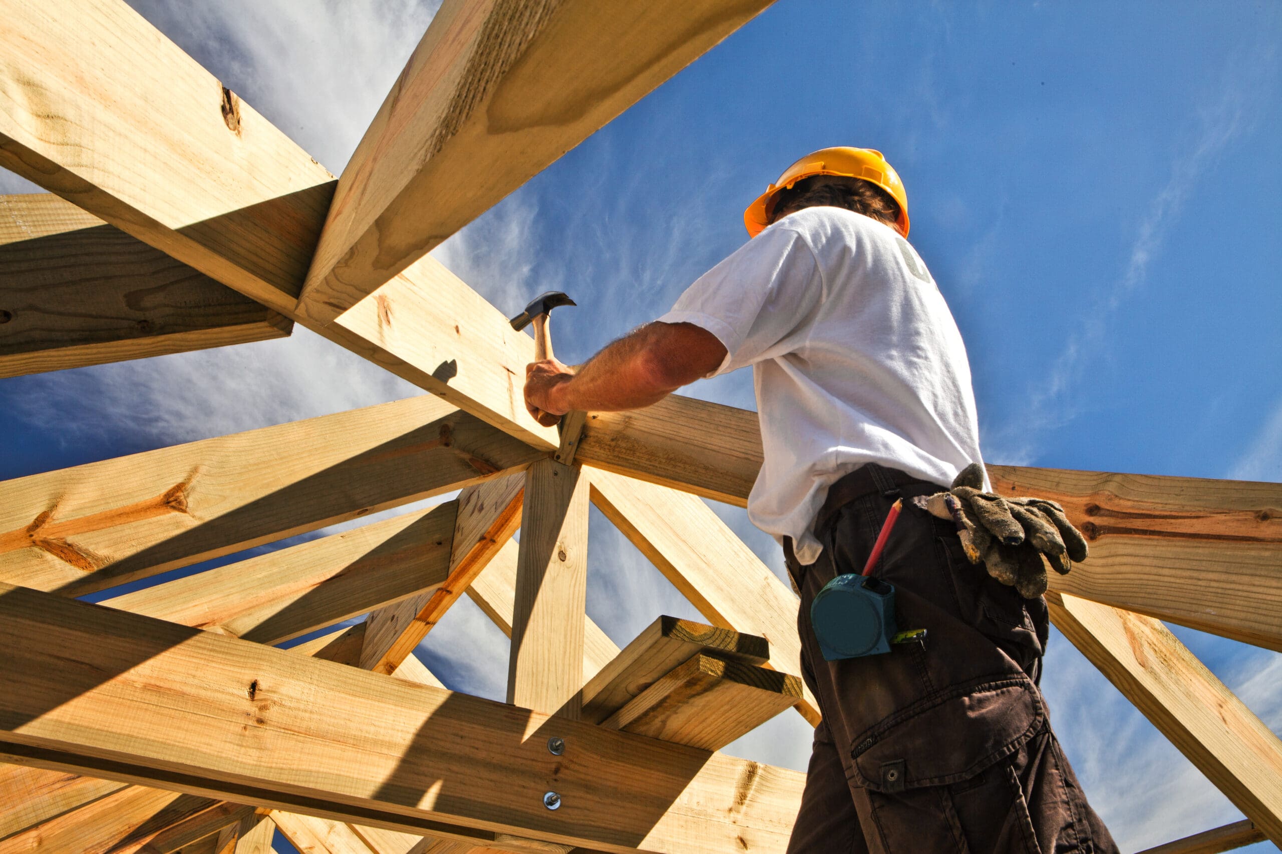Photo of roofer ,carpenter working on roof structure at construction site