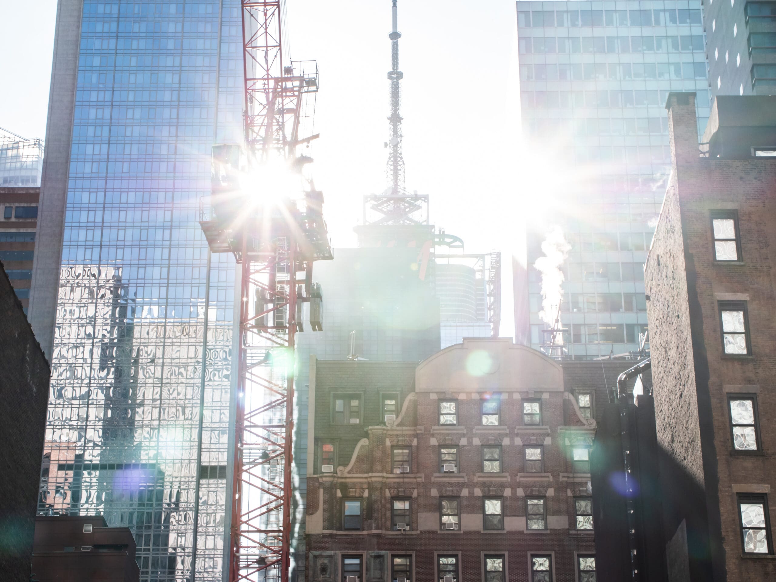 Photo of buildings with construction and crane